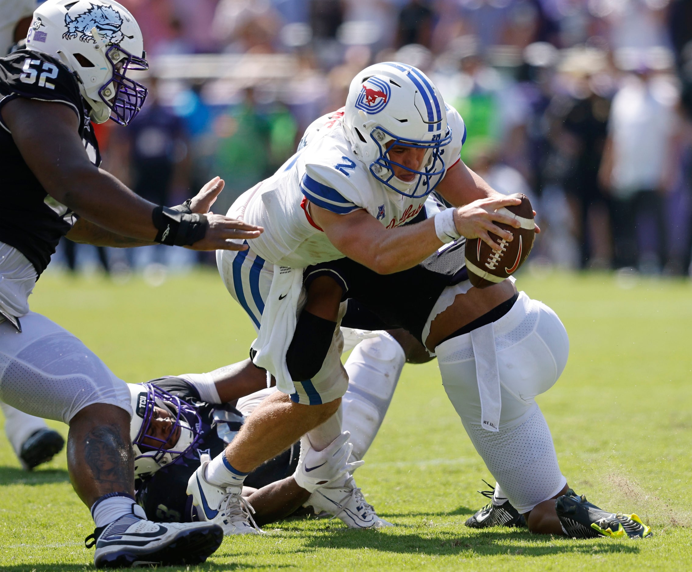 Southern Methodist Mustangs quarterback Preston Stone (2) is tackled by TCU Horned Frogs...