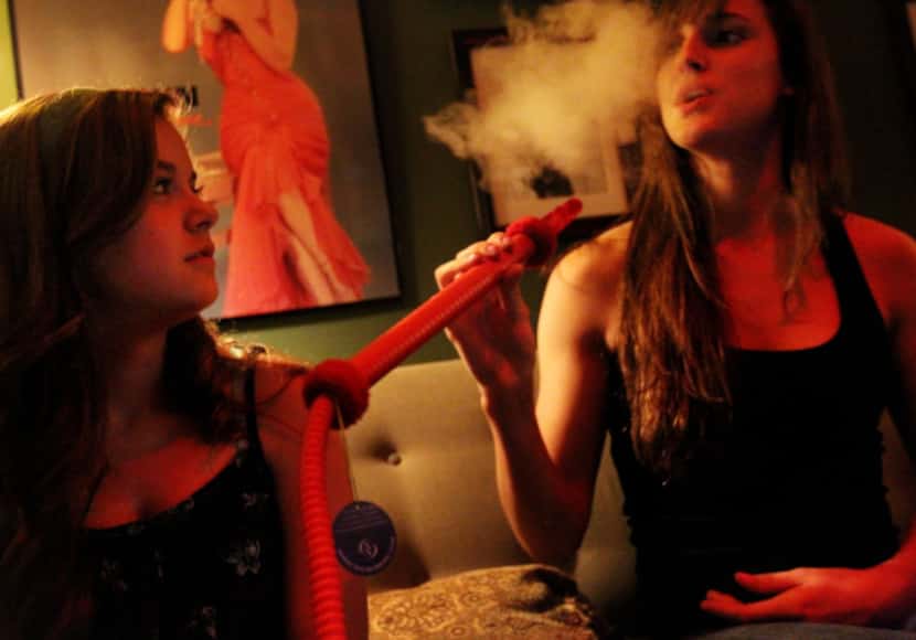 Shelby Thompson (left) and Elissa Ammon shared a hookah at the Peace Pipe in Richardson on...