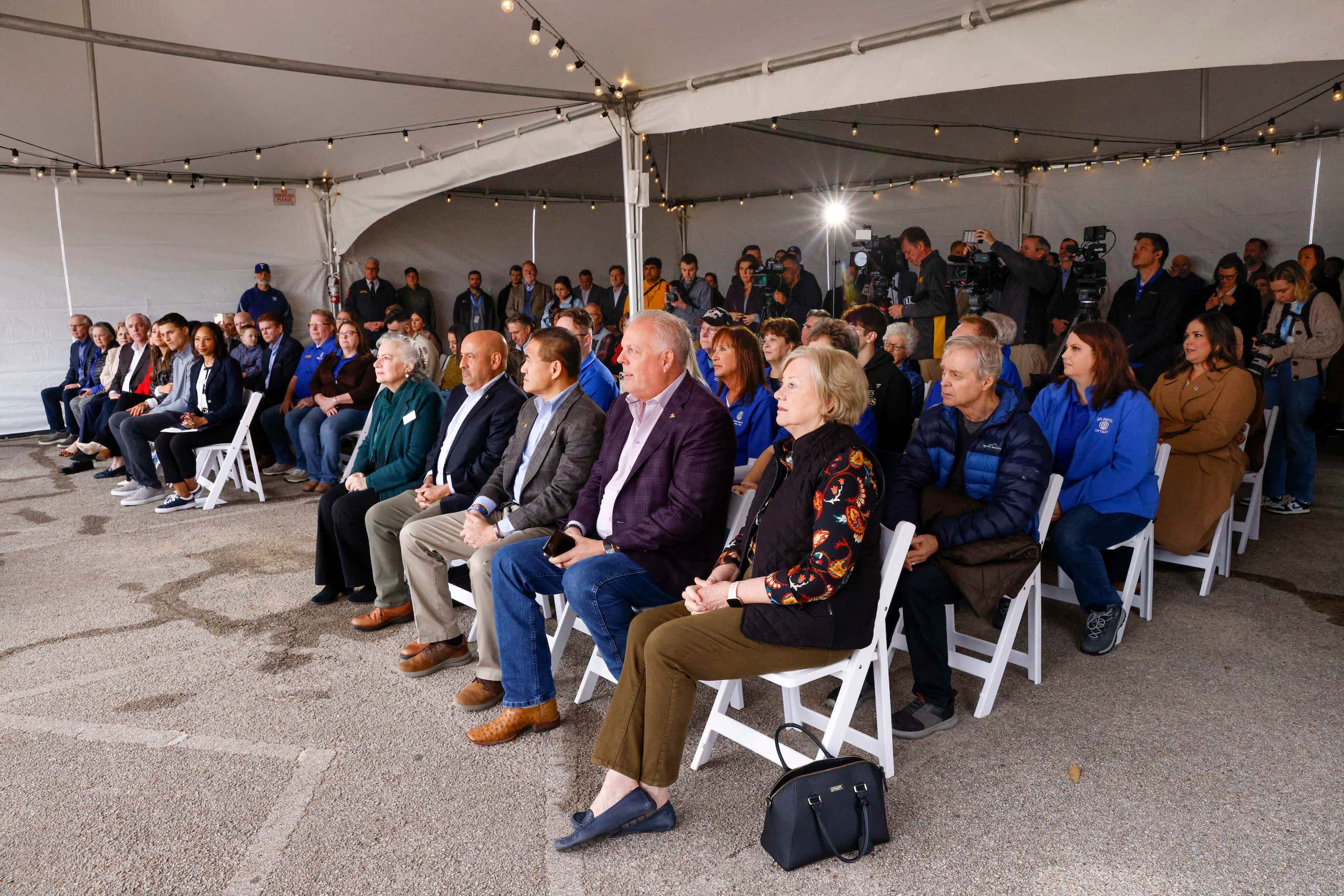 City of Arlington officials along with representatives from the Texas Rangers and MLB listen...