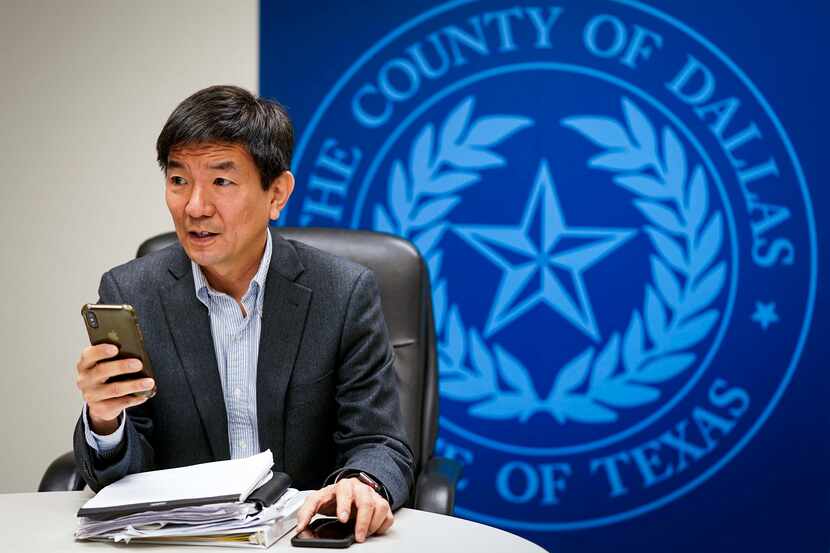 Dr. Philip Huang, Dallas County Health and Human Services director, sends a text message...