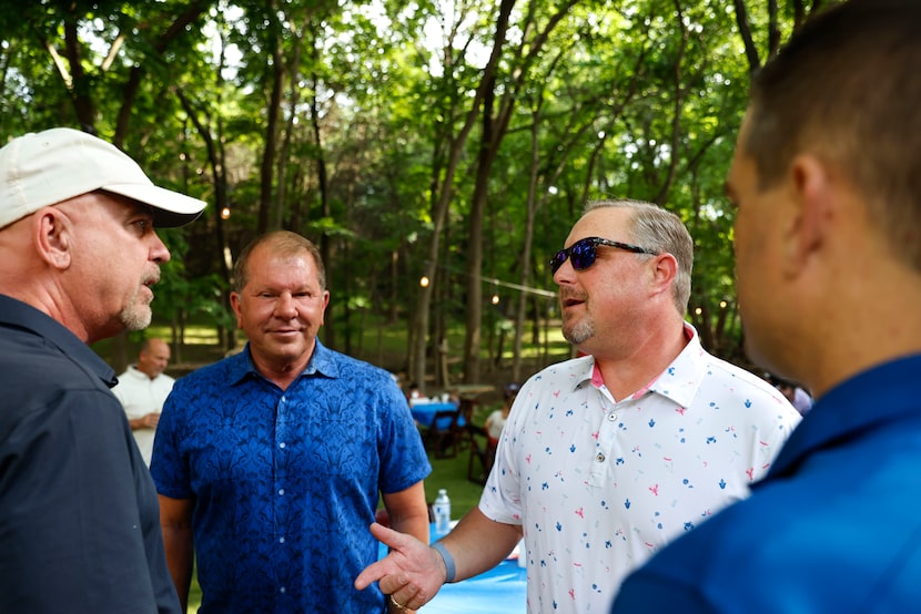 Incumbent state Rep. Justin Holland, R-Rockwall, (second from right), talks some members of...