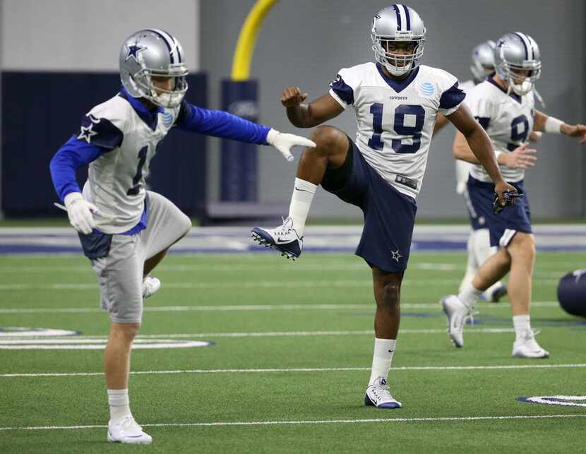 Dallas Cowboys receiver Amari Cooper (19)  stretches alongside Dallas Cowboys wide receiver...