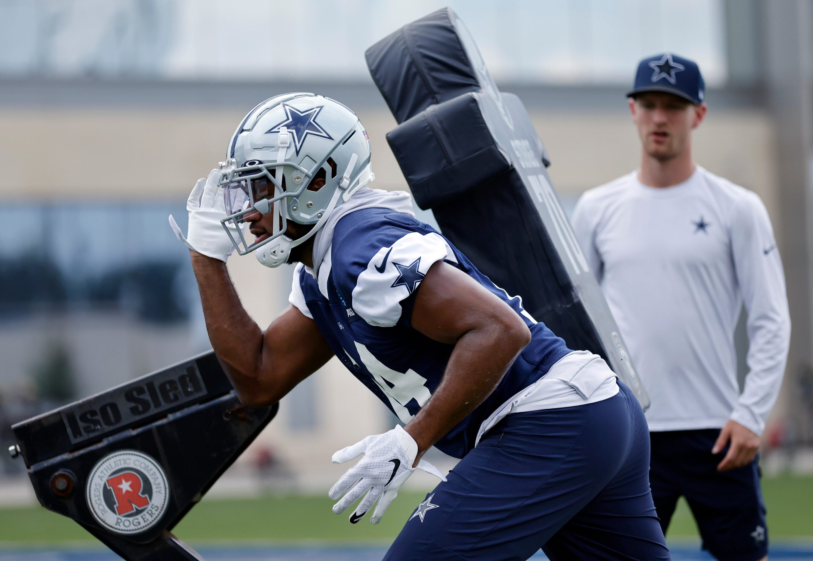 Dallas Cowboys linebacker Jabril Cox (14) fires off the blocking dummy during a training...