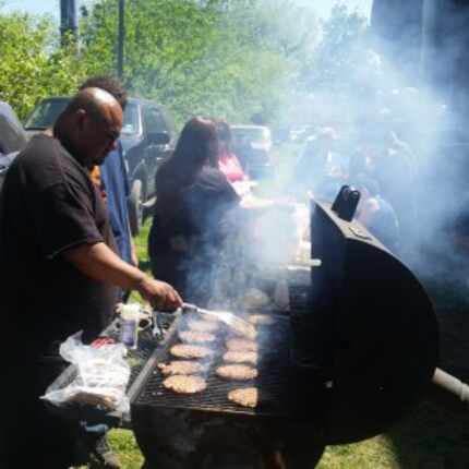  Cadena, left, grilling burgers for those at Saturday's Tent City event. (Marc Ramirez)