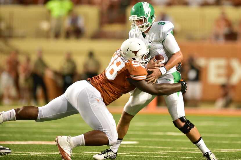 Texas defensive tackle Hassan Ridgeway (98) records one of his six sacks in 2014 against...
