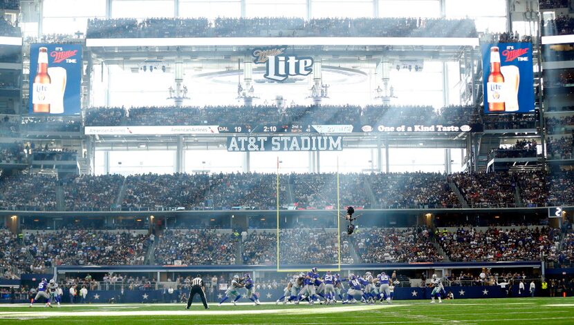 Sunlight streams through the glass doors of AT&T Stadium in Arlington during the fourth...