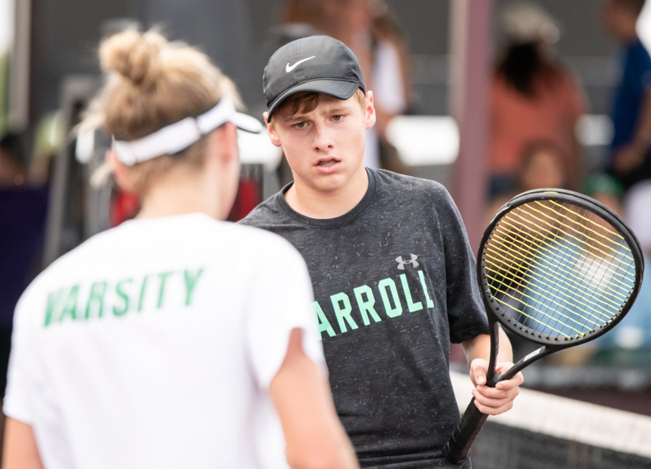 Southlake Carroll's Drake Ferri and Kelly Kunz high five during a doubles match against...