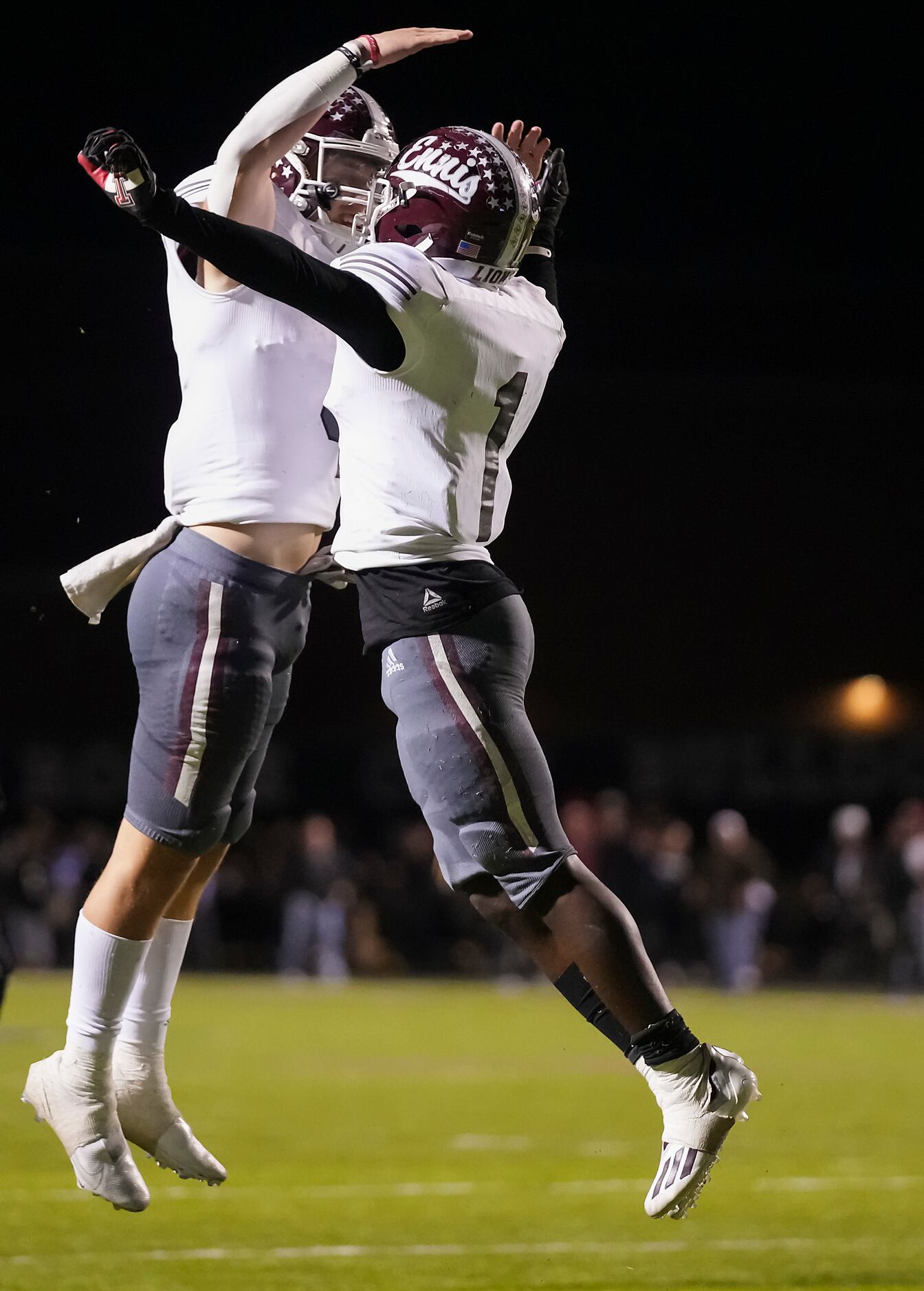 Ennis running back Devion Beasley (1) celebrates with teammate Jace Berry (4) after scoring...
