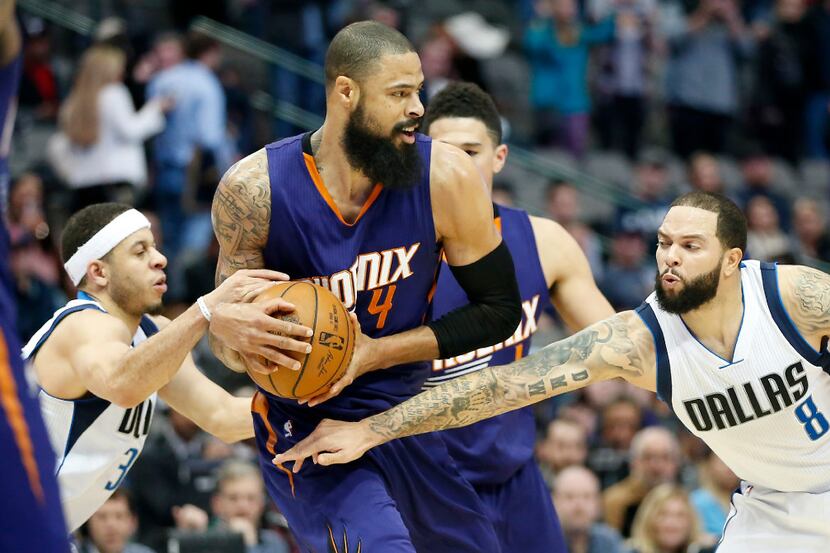 Phoenix Suns center Tyson Chandler (4) is fouled by Dallas Mavericks guard Seth Curry (30)...