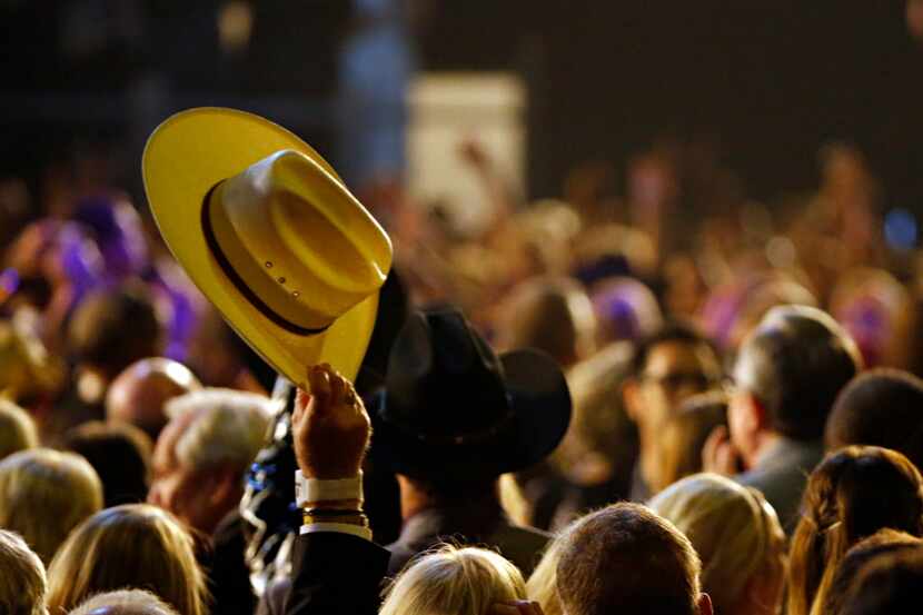 A fan waves his hat in the air during the 2015 Academy of Country Music Awards Sunday, April...