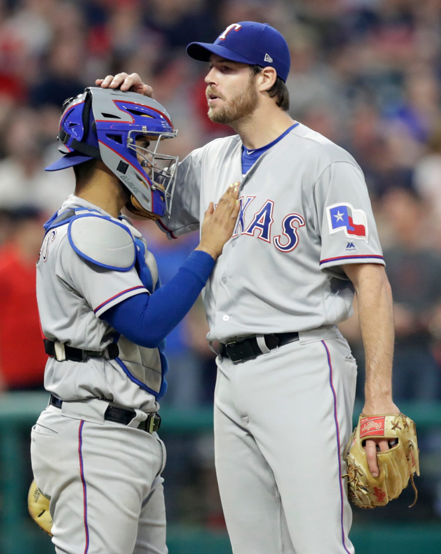 Texas Rangers catcher Robinson Chirinos pats starting pitcher Doug Fister on the chest just...