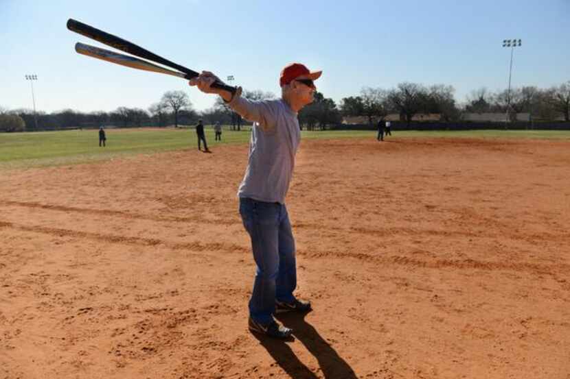 Dick Chaney, 80, warms up before stepping up to bat during an Irving Eagles softball...