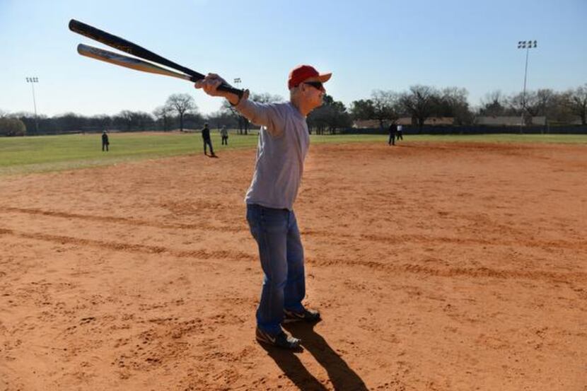 Dick Chaney, 80, warms up before stepping up to bat during an Irving Eagles softball...