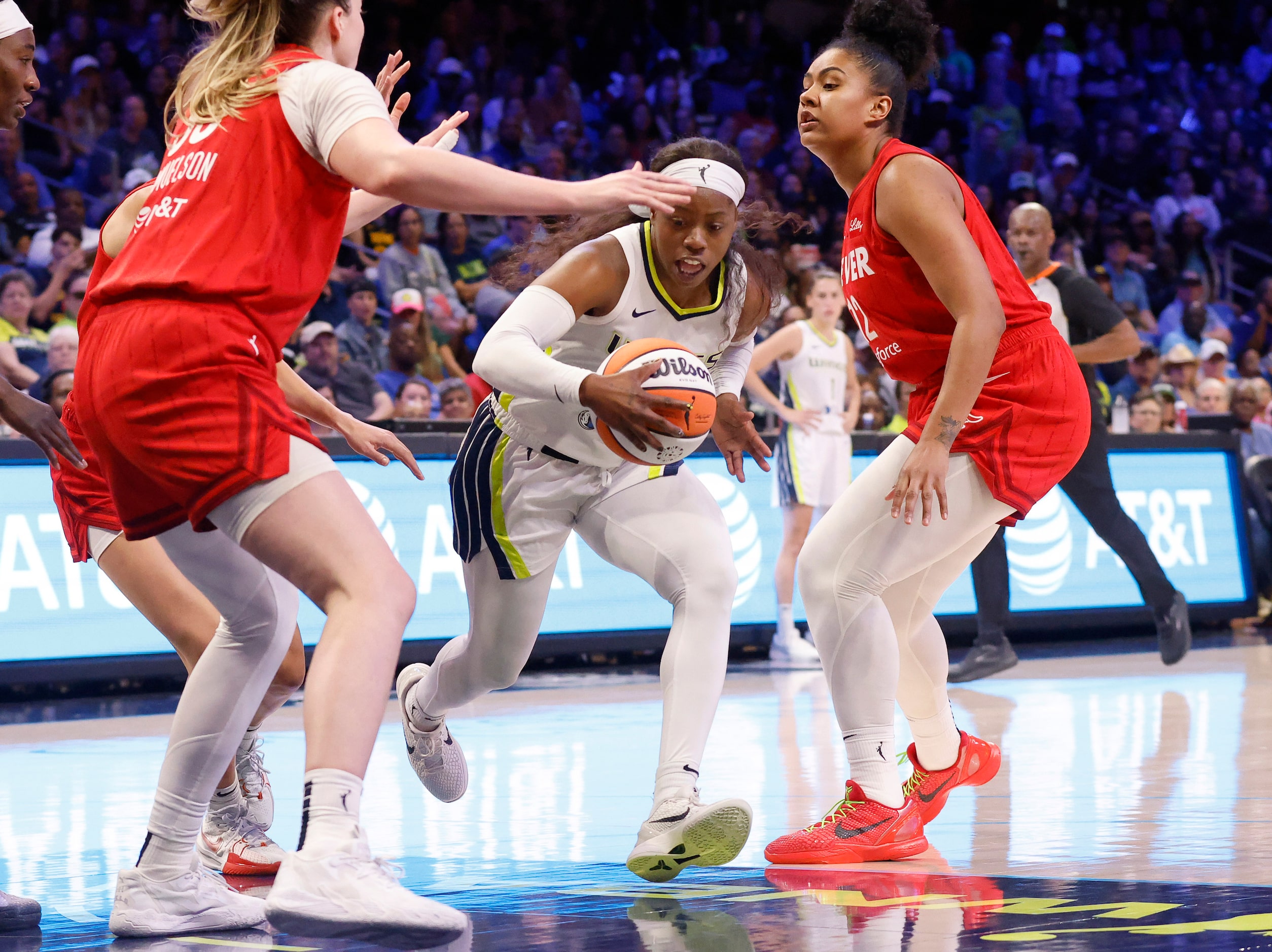 Dallas Wings guard Arike Ogunbowale (24) weaves her way through the Indiana Fever defense...