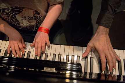 Ben Schneider (left) is joined at the piano by Ben Folds as the two play together during a...