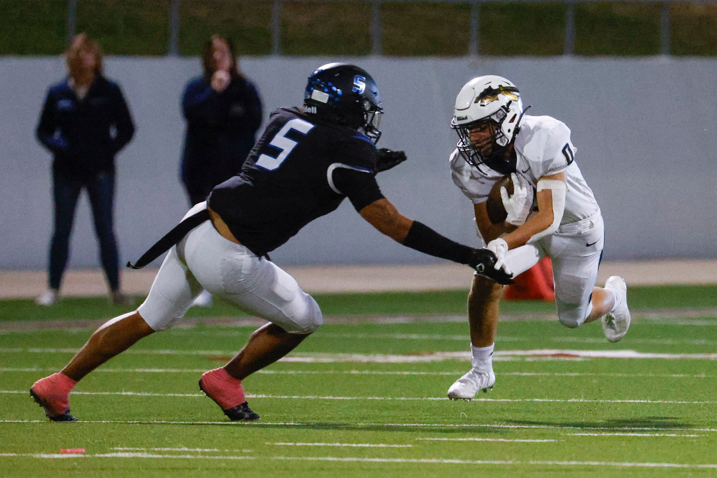 Byron Nelson’s Ashton Williams (5) reaches to tackle Keller high’s Kyle Owens during the...