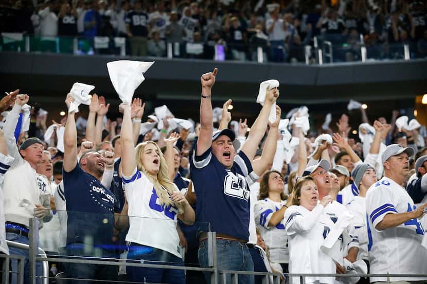 Dallas Cowboys fans cheer their team late in the fourth quarter against the Seattle Seahawks...
