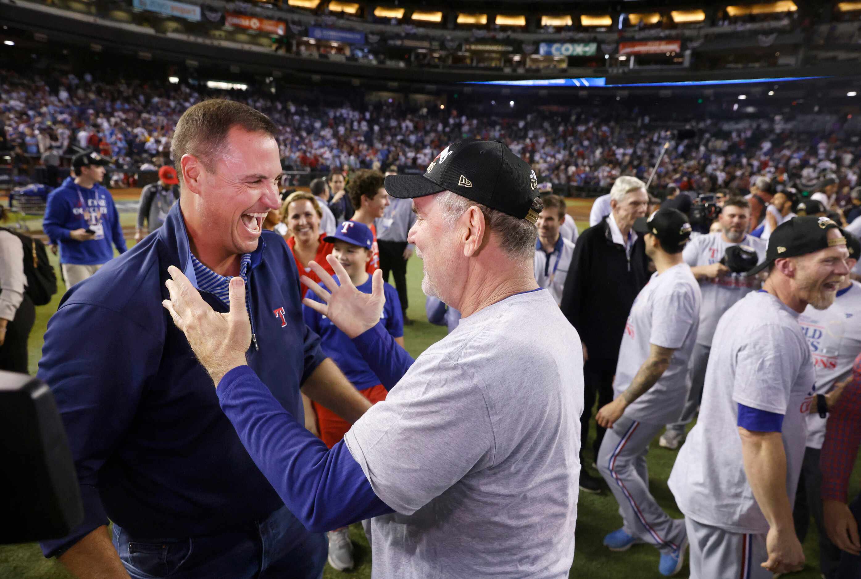 Texas Rangers general manager Chris Young (left) and manager Bruce Bochy celebrate their...