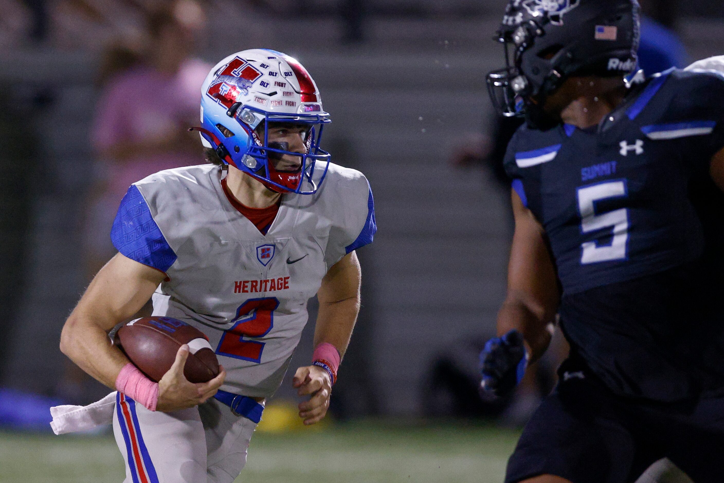 Midlothian Heritage quarterback Kaden Brown (2) runs the ball past Mansfield Summit...