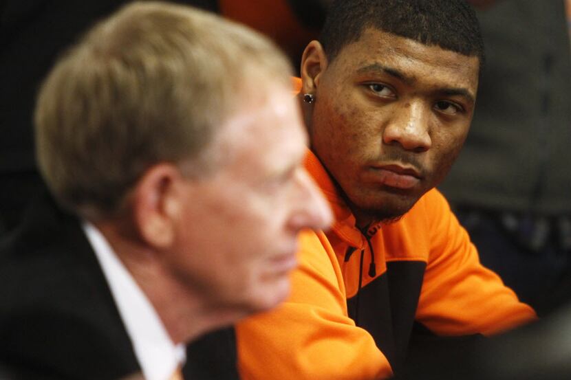 Oklahoma State basketball player Marcus Smart, right, and OSU athletic director Mike Holder...