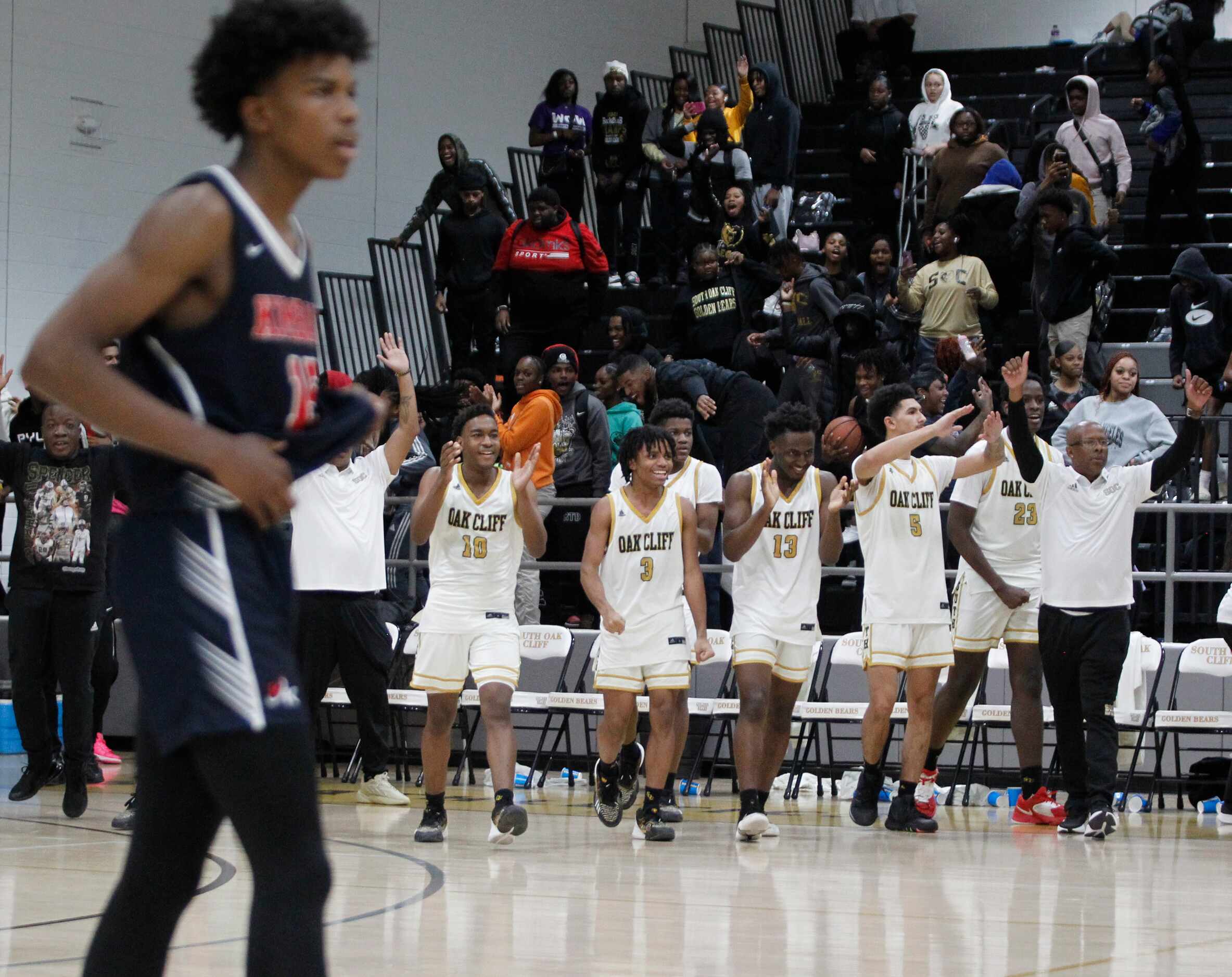 The South Oak Cliff bench reacts after the final buzzer sounded in their 53-50 victory over...