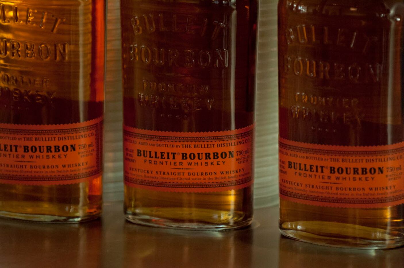 Bottles of Bulleit Bourbon atop the bar at a party hosted by men's clothing retailer Ledbury...