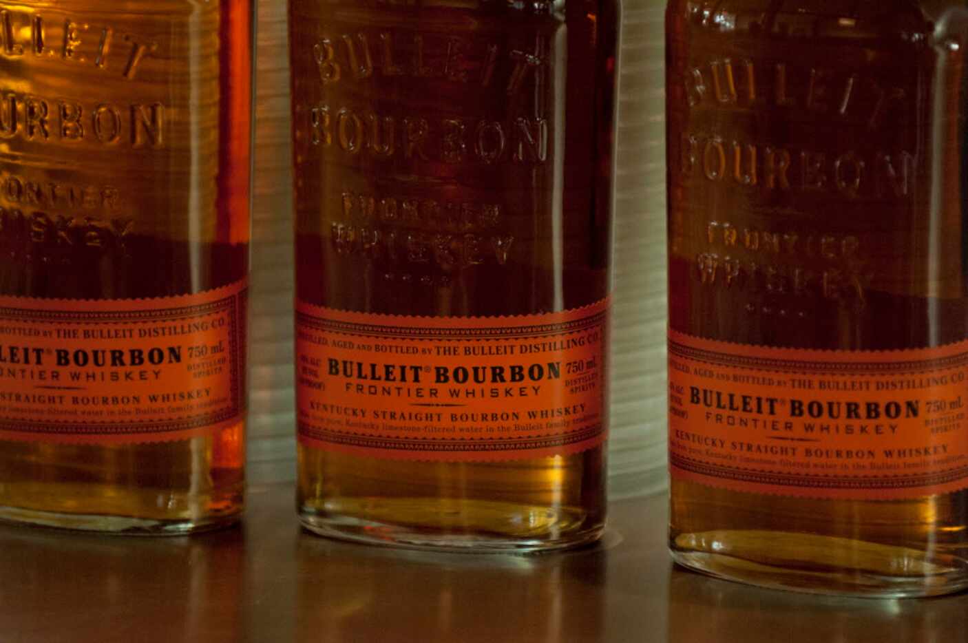 Bottles of Bulleit Bourbon atop the bar at a party hosted by men's clothing retailer Ledbury...