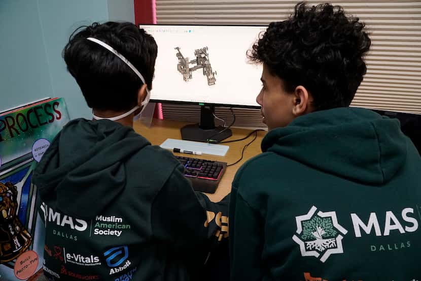 Marvels of MAS robotics team members Yusuf Hussain, 13, and Hazem Omar, 14, work on a...