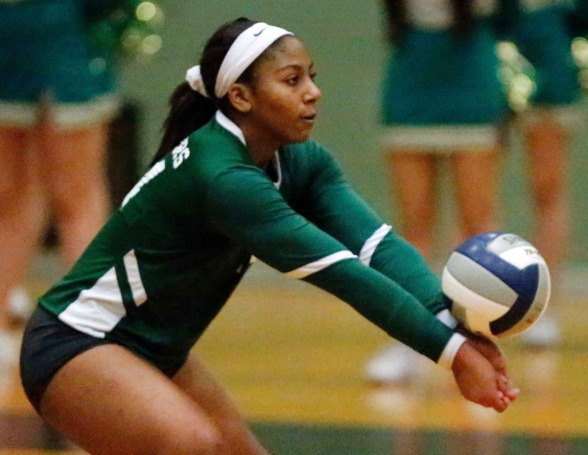 Lebanon Trail High School outside hitter Rayna Williams (14) takes a serve during game two...