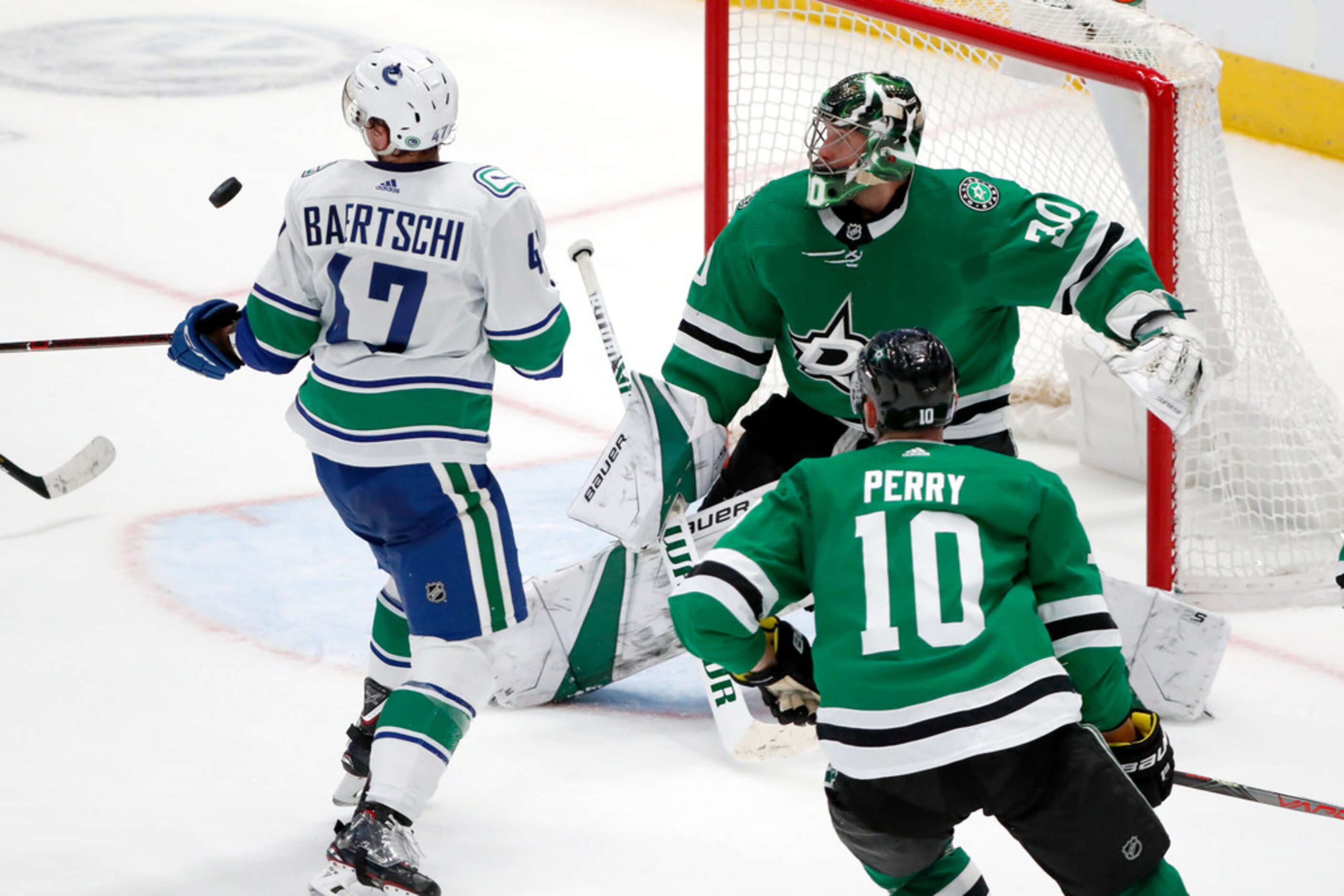 Vancouver Canucks left wing Sven Baertschi (47) and Dallas Stars right wing Corey Perry (10)...