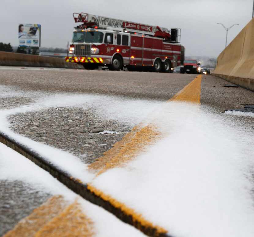 Ice covered the overpass on Highway 67 over Hampton Road on Sunday afternoon in Dallas. The...