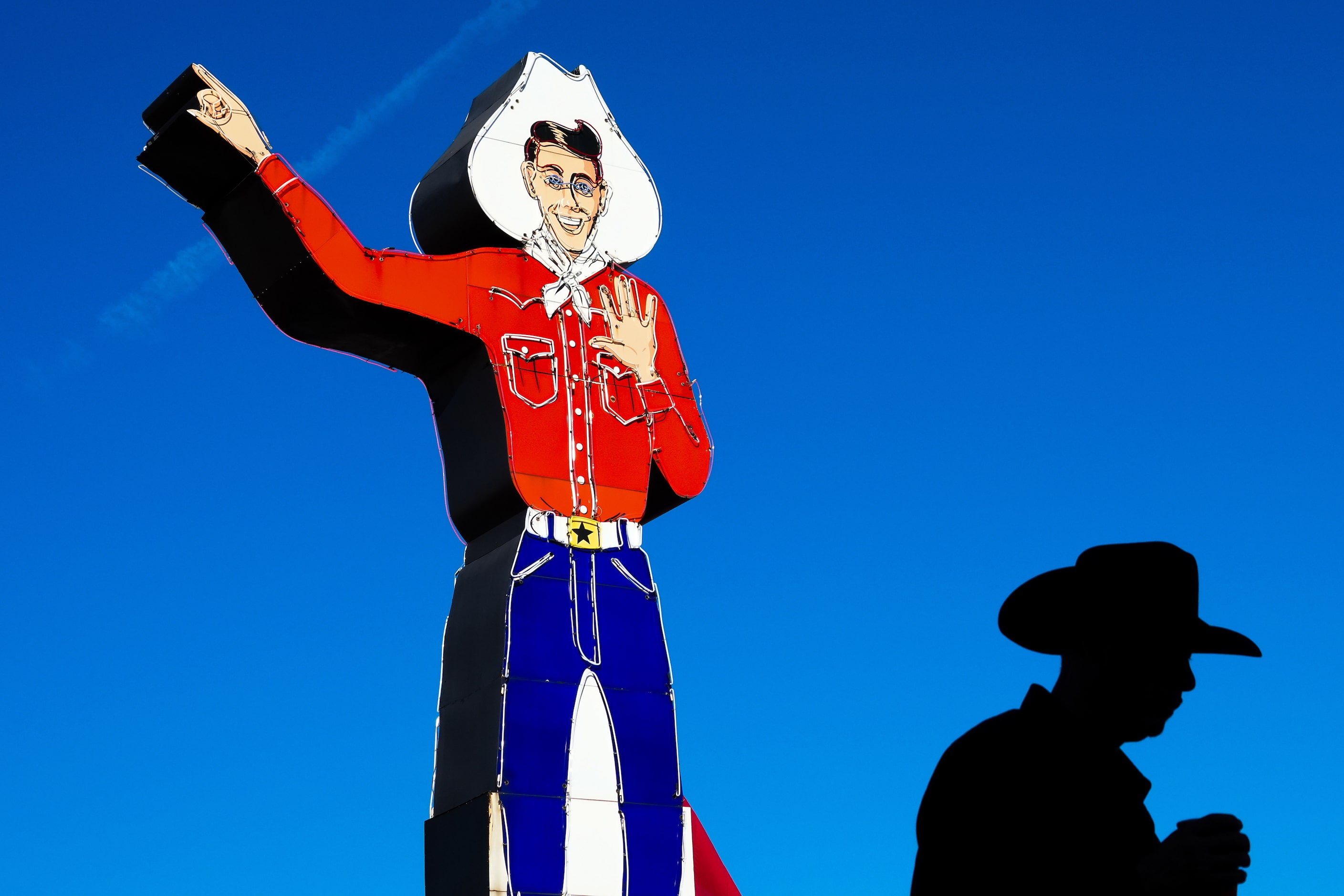 Neon Big Tex points to blue skies above the State Fair of Texas on Sunday, Sept. 29, 2024,...