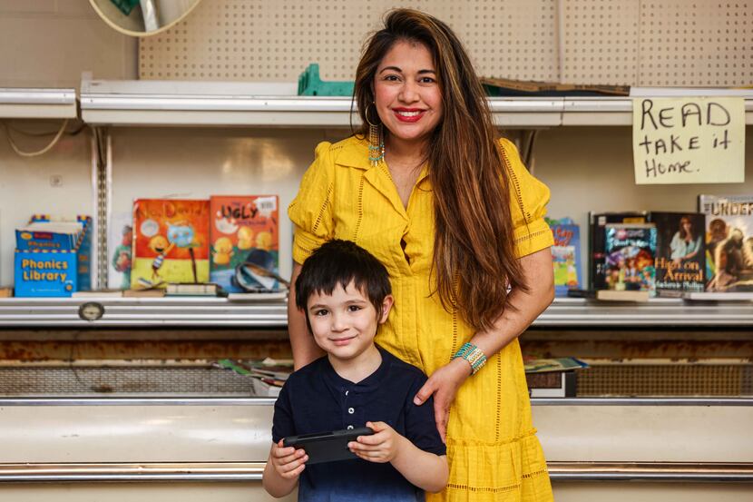 Nelly Cuenca and her 5-year-old son, Bean, who started a library inside Allen’s, a grocery...