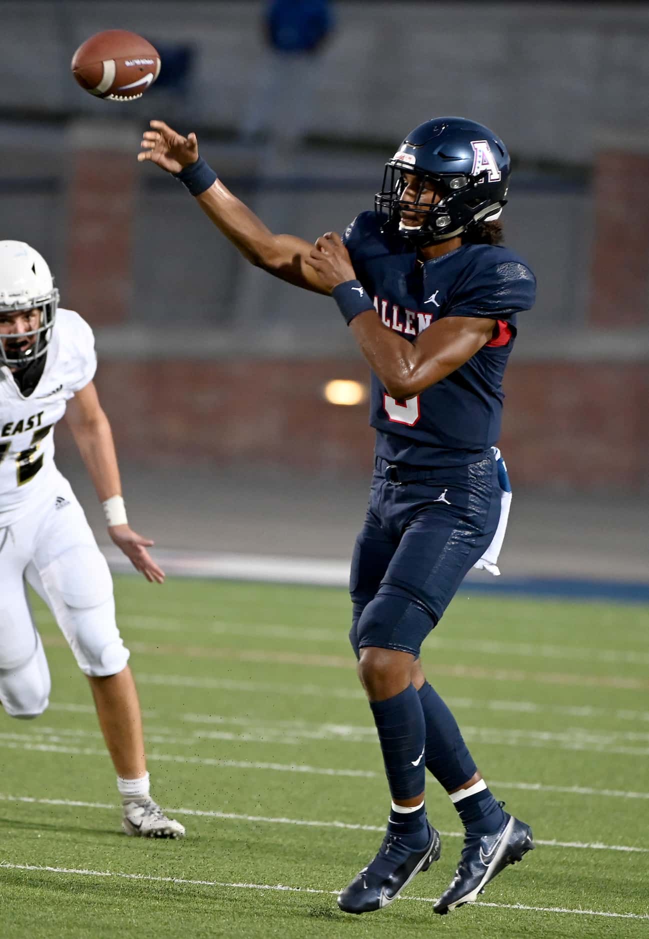 Allen quarterback Mike Hawkins passes in the first half during a high school football game...