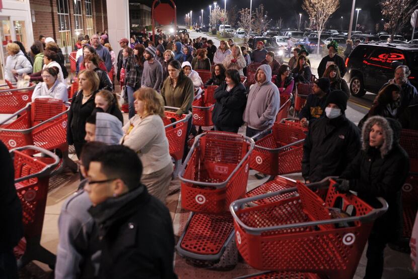 FILE- In this  Friday, Nov. 25, 2011, file photo, a crowd of shoppers wait outside the...