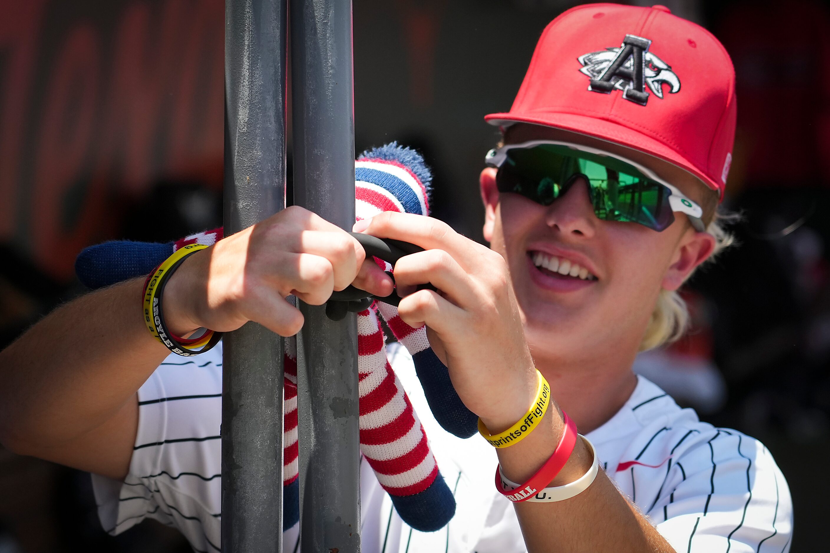 Argyle outfielder Nate Beck attaches a rally monkey in the dugout before a UIL 4A baseball...