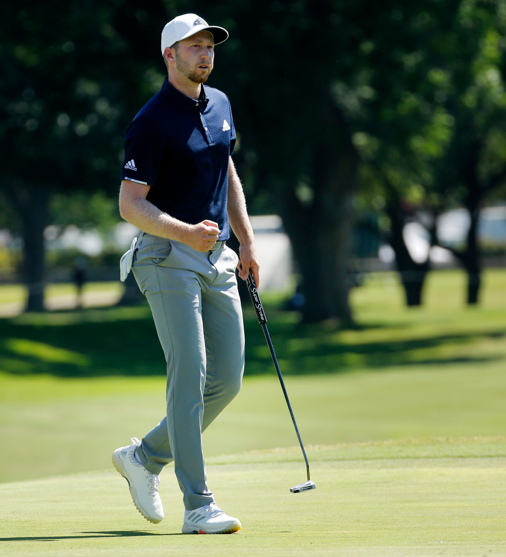 PGA Tour golfer Daniel Berger pumps his fist as he hit a birdie putt on No. 18 to make a...