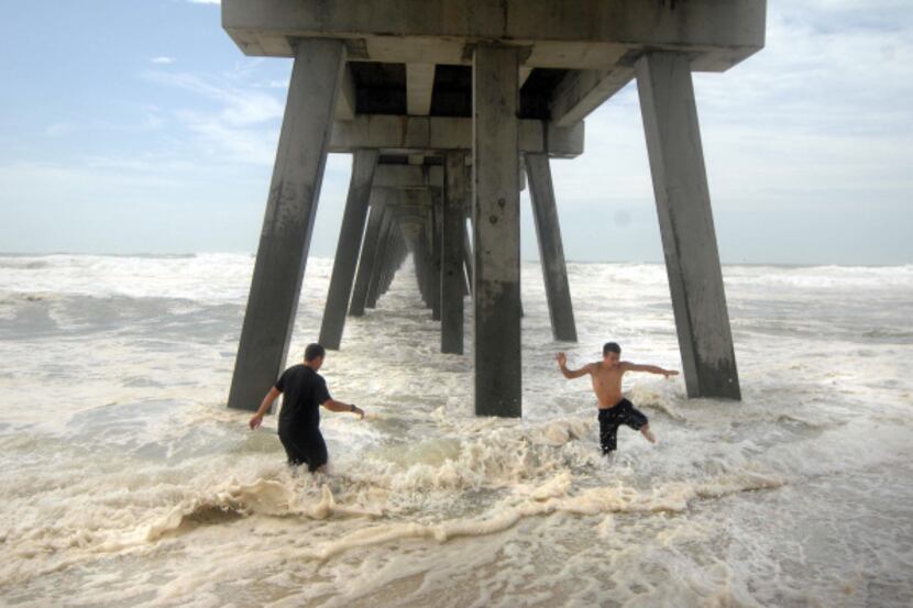 Hurricane Isaac kicked up enough of a surf for these teens to play in under  the Navarre...