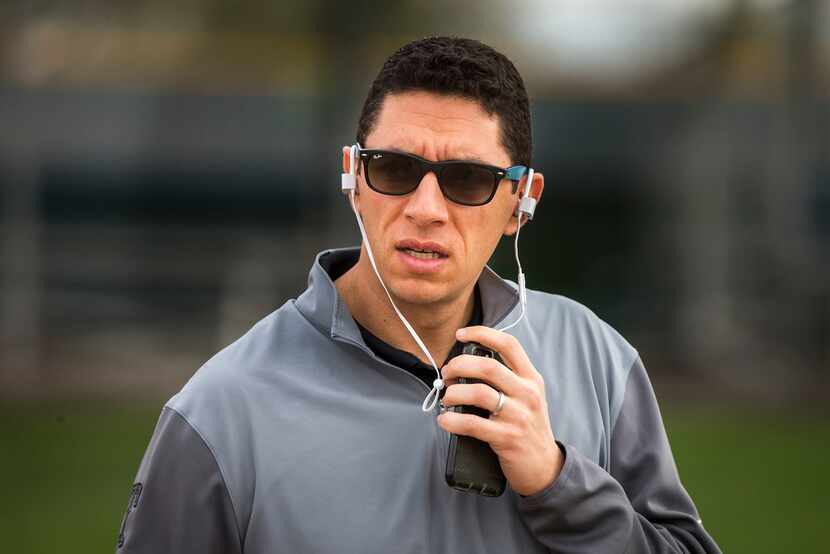 Texas Rangers general manger Jon Daniels works the phones as he watches the first spring...