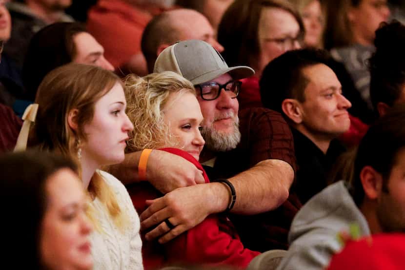 Amy Hightower gets comforted by her husband Phillip Hightower, followed by their son Max’s...