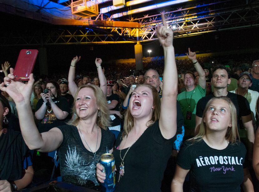 Journey fans watch them perform at the Gexa Energy Pavilion on Saturday, August 25, 2012    ...