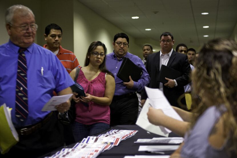 Job seekers picked up paperwork at a career fair in San Antonio last month. The state...