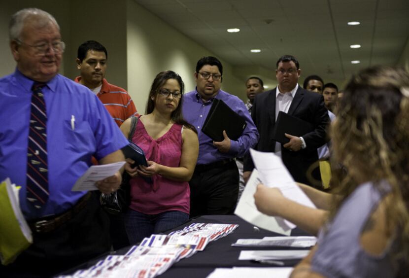 Job seekers picked up paperwork at a career fair in San Antonio last month. The state...