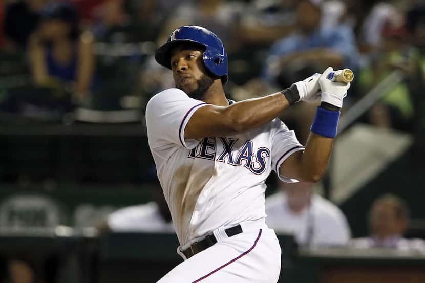 Texas Rangers shortstop Elvis Andrus follows through on a line out to third in the eighth...