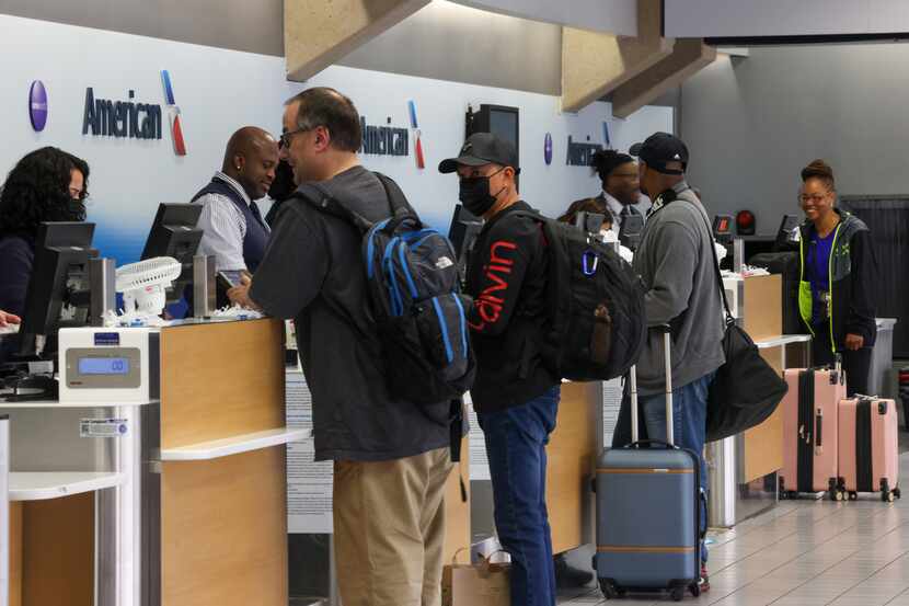 Travelers check in for their flights at DFW International Airport.