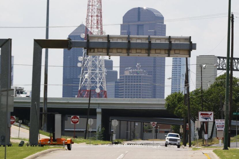 The Dallas skyline emerges over Interstate 30 at Second Avenue in Fair Park on Thursday. A...