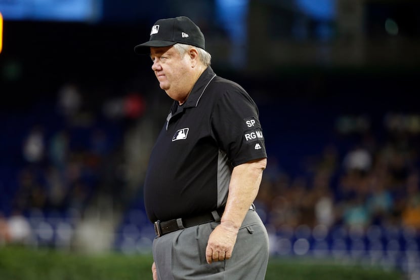 Umpire Joe West works first base during a baseball game between the Cincinnati Reds and...