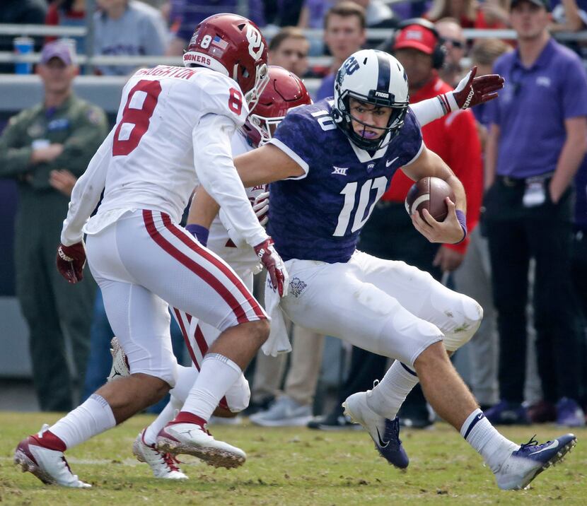 TCU Horned Frogs quarterback Michael Collins (10) looks for running room as Oklahoma Sooners...