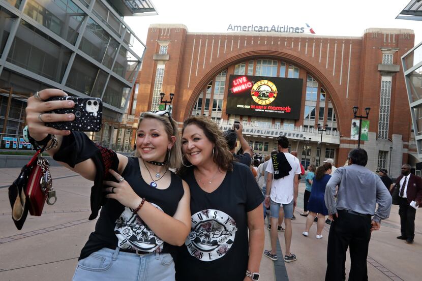 Emma Bradley, left, and Stacy Bradley take a selfie as fans line up to see Guns N' Roses at...