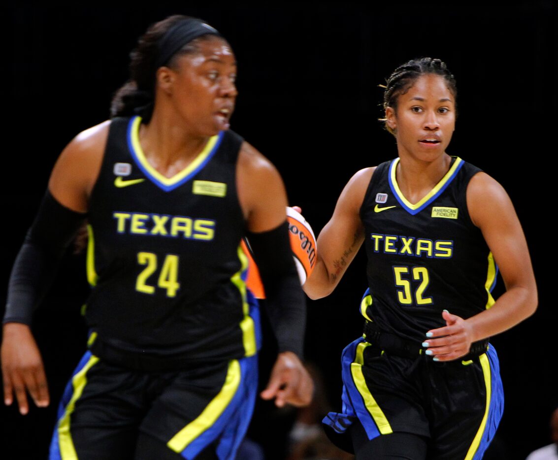 Dallas Wings guard Tyasha Harris(52), right, brings the ball up-court behind guard Arike...